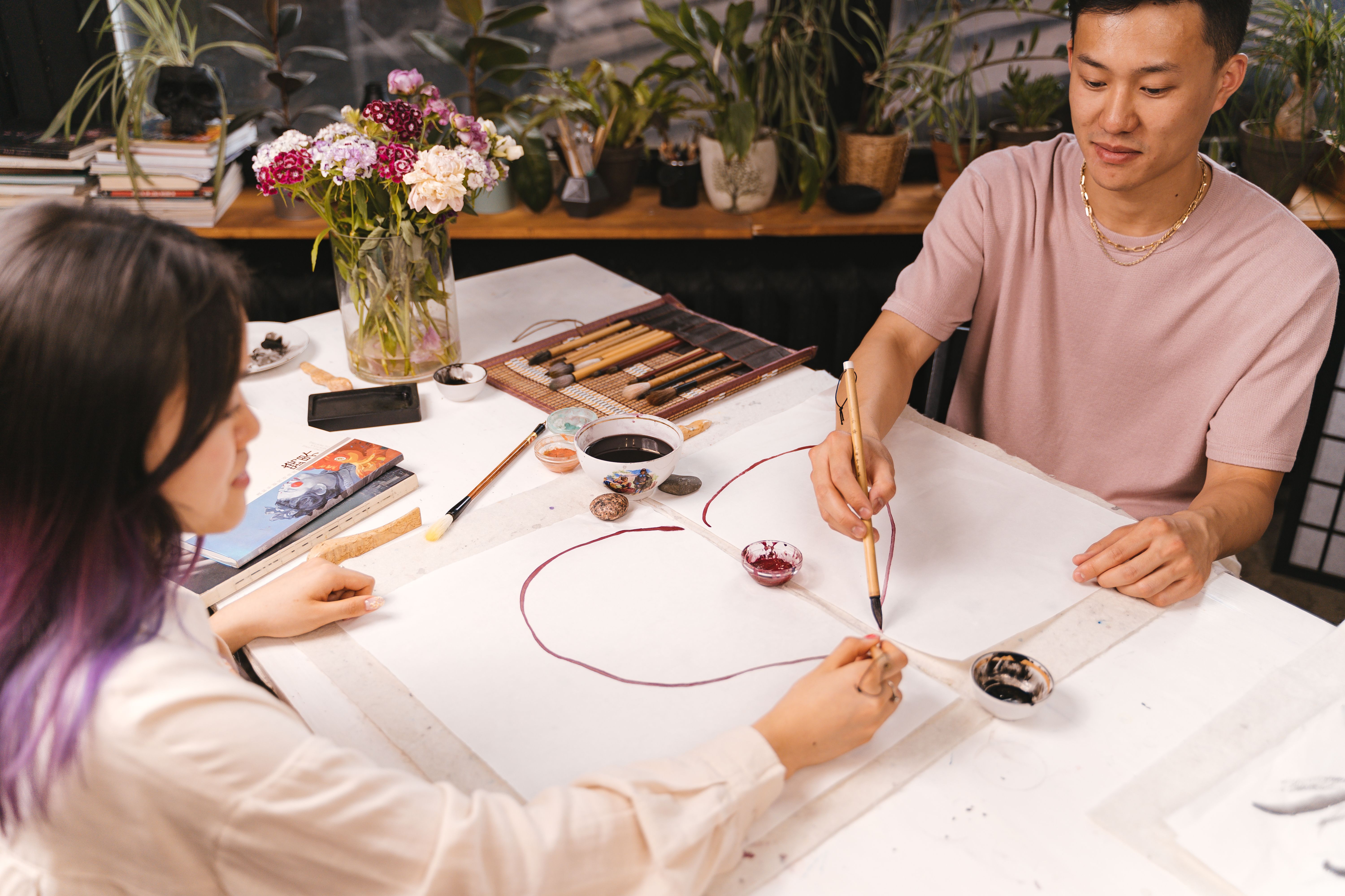 A couple paints together indoors, nurturing creativity and imagination in their relationship